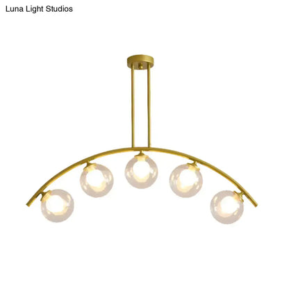 Decorbites gold island pendant with clear white shade features five spherical glass bulbs in a curvy arched design