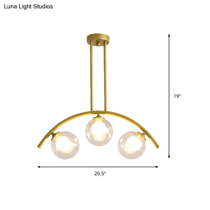 Decorbites gold island pendant with clear white shade features three spherical glass bulbs on a curved metal frame