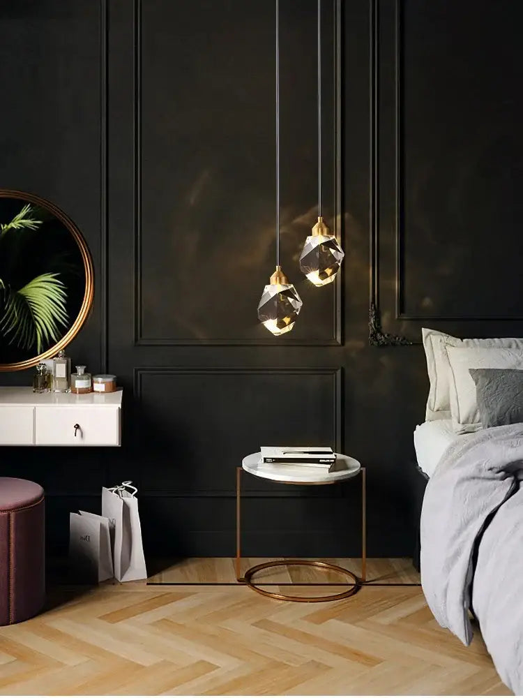 Modern gold k9 crystal linear kitchen pendant light with two faceted crystal shades and gold-toned metal fixtures emitting warm light 3200k