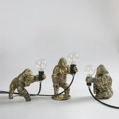 Modern gold king kong resin night light featuring three golden gorilla figurines holding edison bulb decorbites king kong