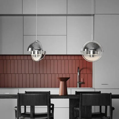 Two chrome spherical danish pendant lights hang above a dining table accenting modern decorbites danish pendant style