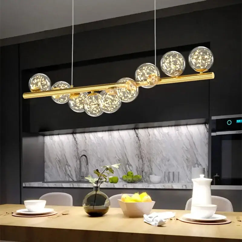 Modern gold led ceiling chandeliers featuring clear glass spheres with warm led lights for dining room illumination