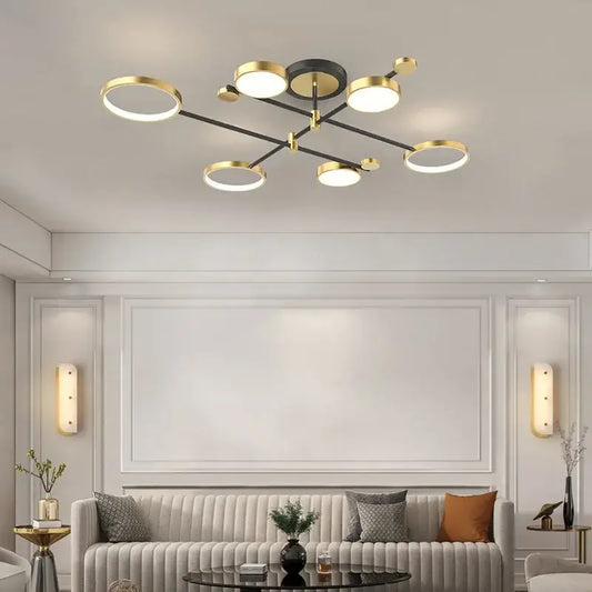 Modern gold led ceiling lamp with black circular base and six illuminated ring bulbs for living room lighting