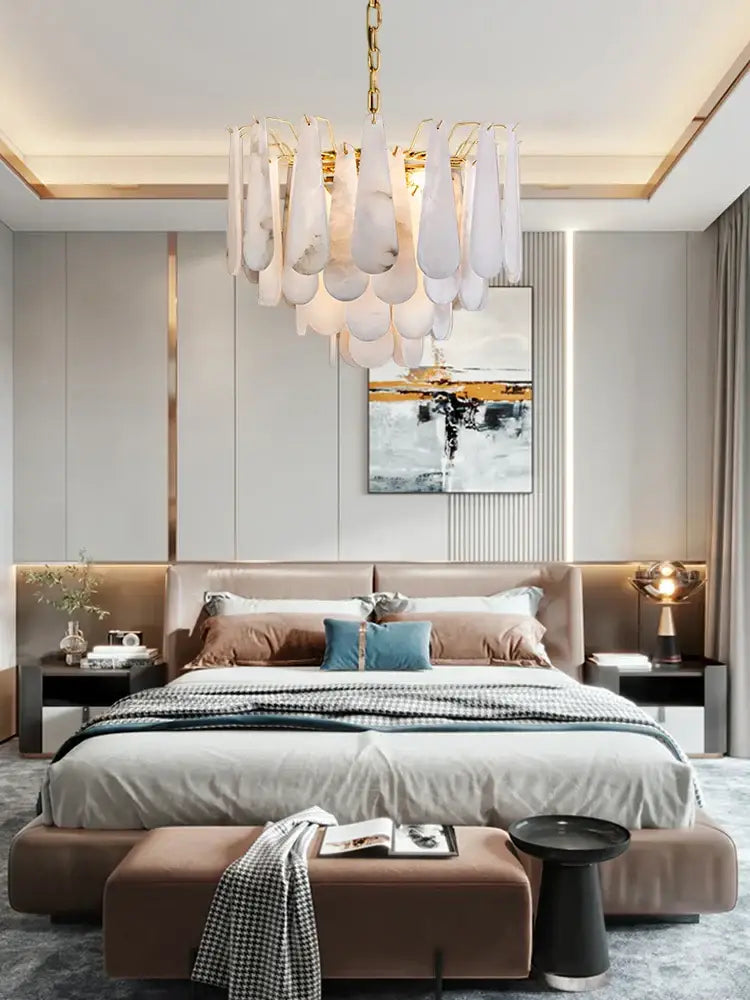 A modern gold led dimmable marble chandelier with cascading white teardrop glass pendants for dining room use