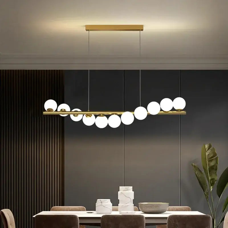 Modern gold led long chandelier with sleek horizontal bar and white glass ball g9 led bulbs for dining room decorbites glass ball