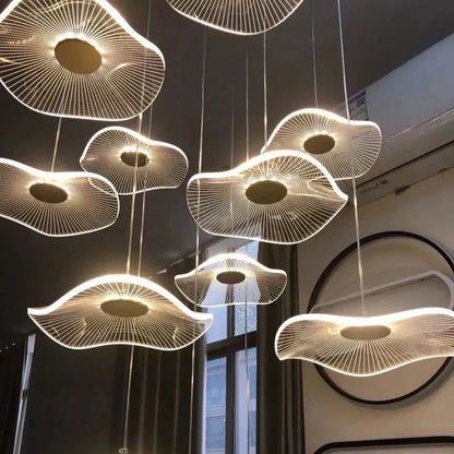 Modern gold led lotus chandelier featuring white fan-like pendant lights with glowing central illumination for decorbites gold led decor