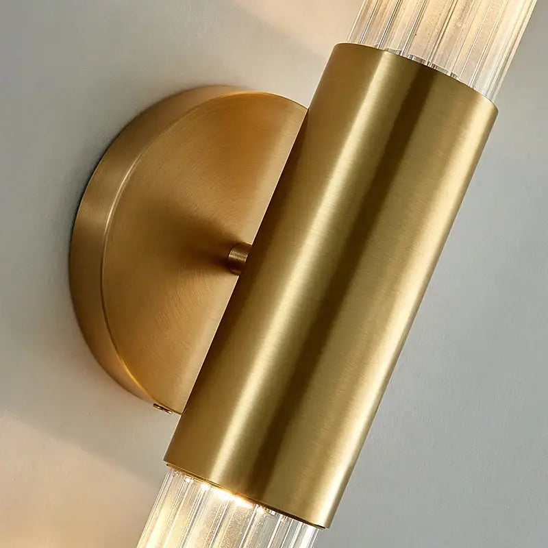Modern gold led sconce with brass finish and clear white ribbed glass shades for bedroom wall lighting