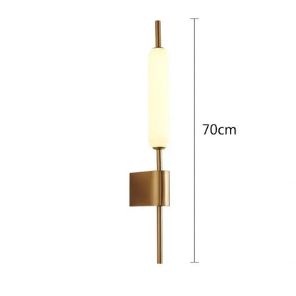 Modern gold led wall light with a brushed brass finish and frosted glass diffuser for bedroom wall lighting