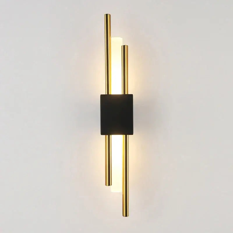 Modern gold led wall sconce with sleek black rectangular base and three vertical rods for bedroom ambient lighting decorbites led wall