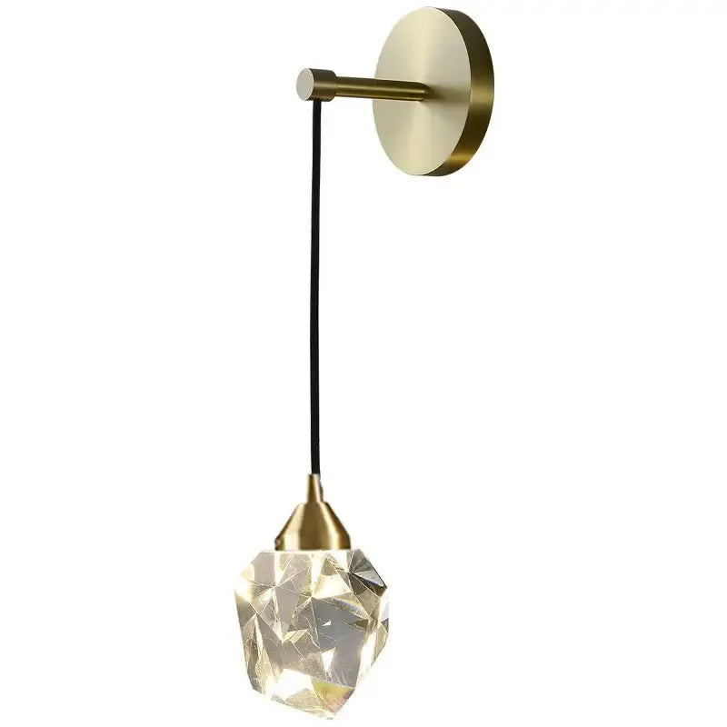 Modern gold led wall sconce with brass finish and faceted crystal pendant glowing warmly for living room use