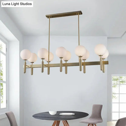 Modern brass-finished ceiling light fixture with gold linear design and white glass frosted globe shades