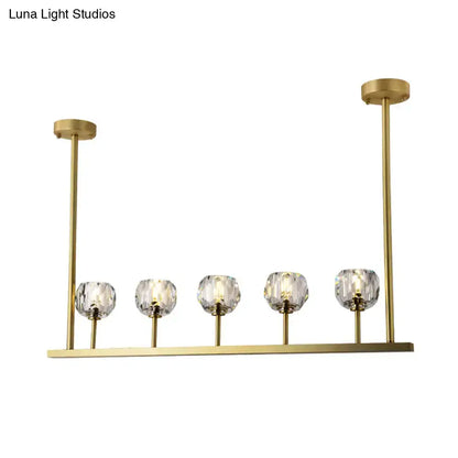 Gold-toned decorbites™ 5-head linear crystal ball pendant light with five faceted crystal globe shades for dining rooms