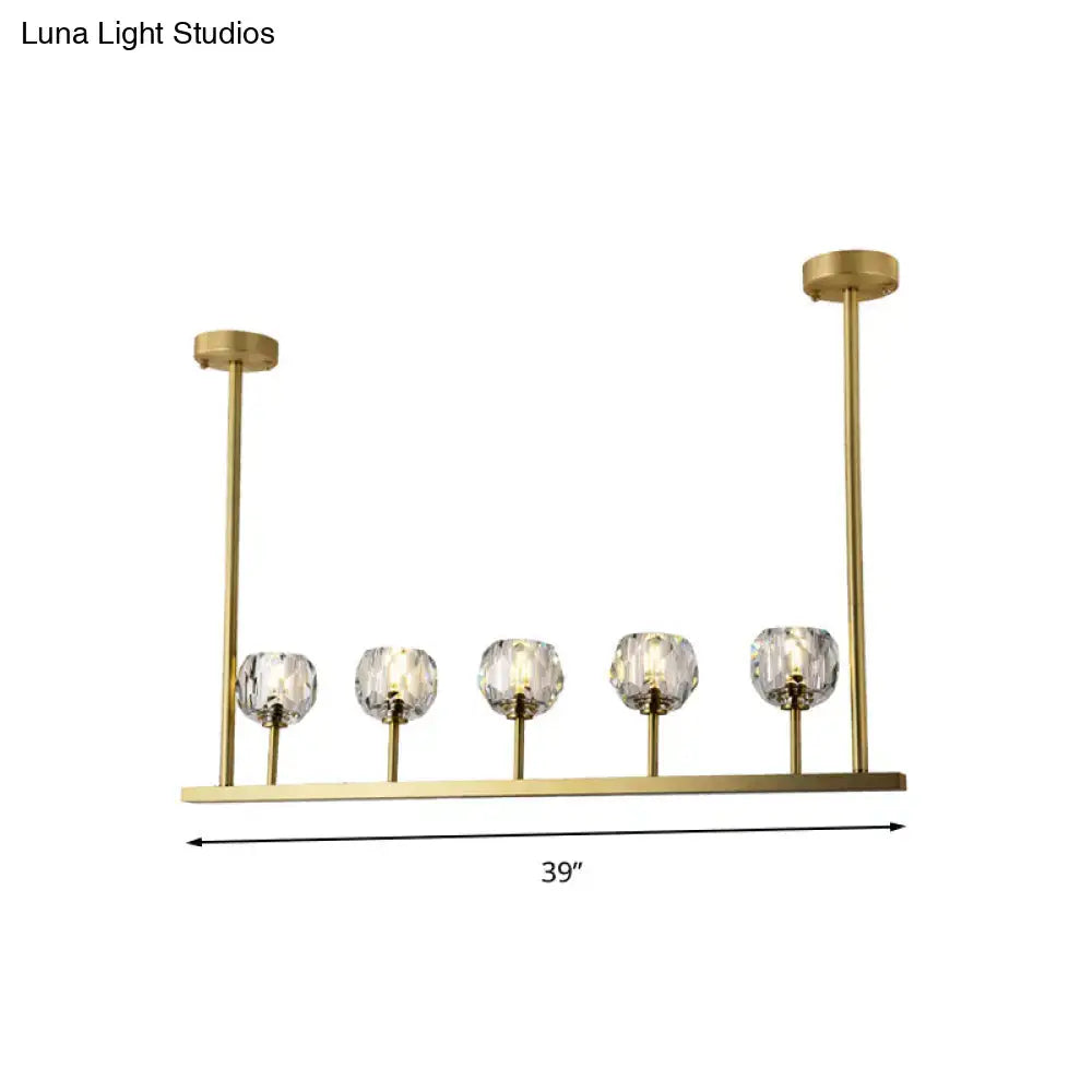 Gold-toned modern 5-head linear crystal ball pendant light fixture with faceted crystal globe shades for dining room