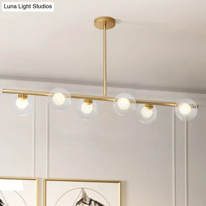 Modern gold linear island light with five clear glass globe shades for kitchen island light fixture
