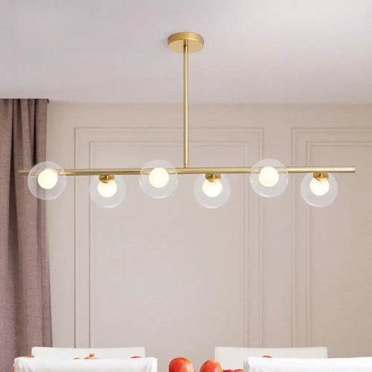 Modern gold linear island light fixture with five clear glass globe shades brass island light fixture