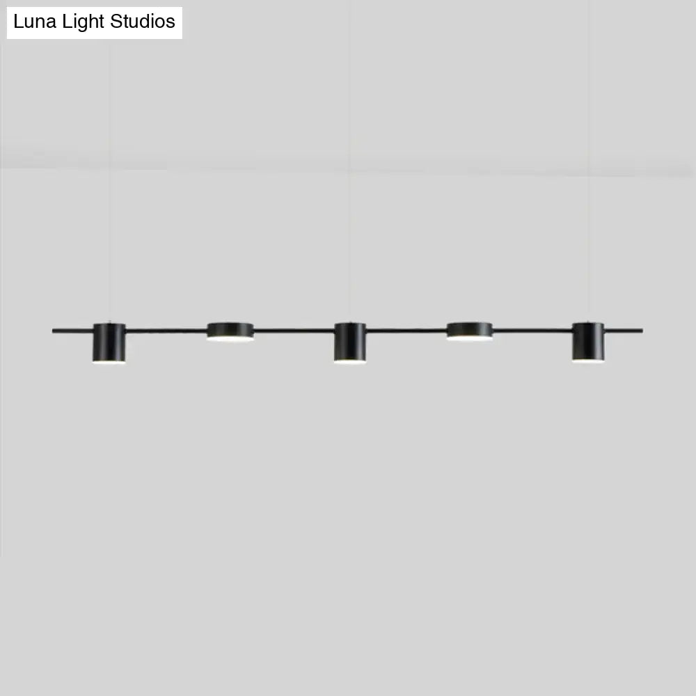 Modern gold linear shaped led pendant light with five black cylindrical fixtures for dining room illumination
