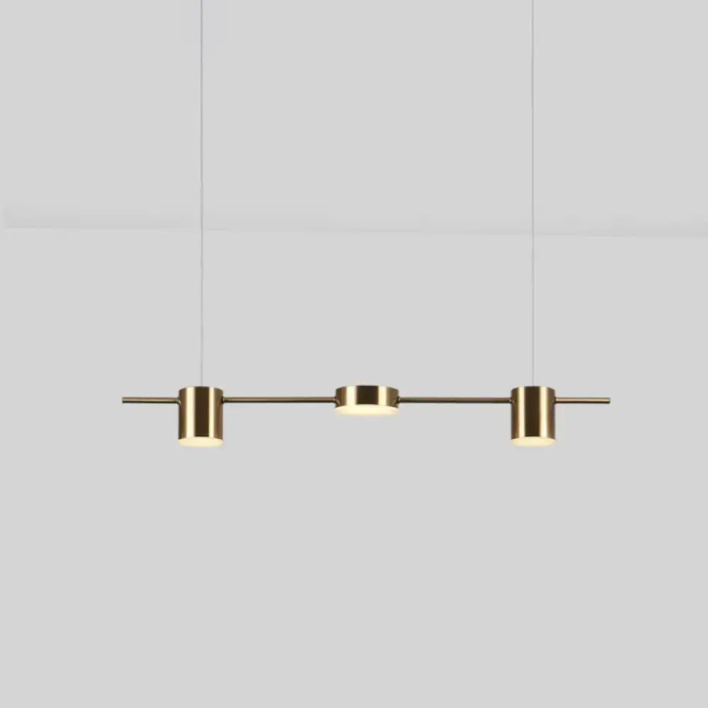 Modern gold linear shaped led pendant light with three brass cylindrical fixtures for dining room use