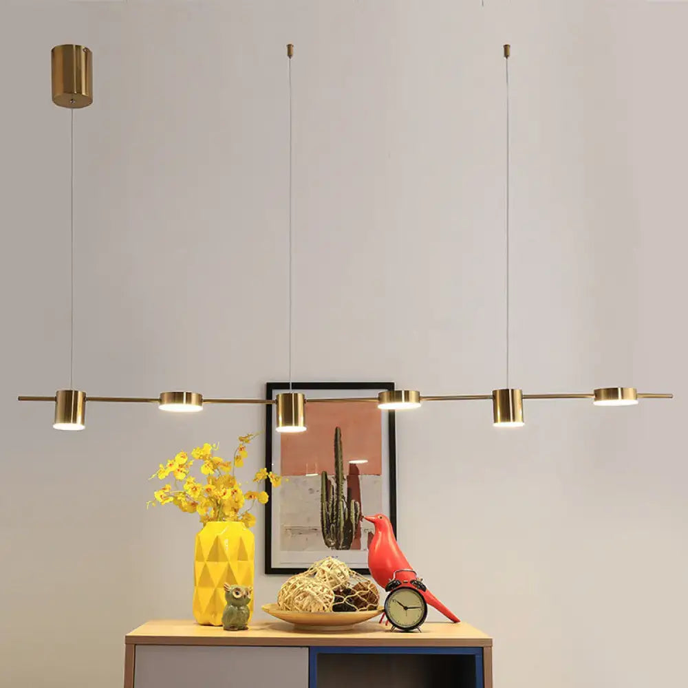Modern gold linear shaped led pendant light with sleek horizontal bar and cylindrical fixtures for dining room use