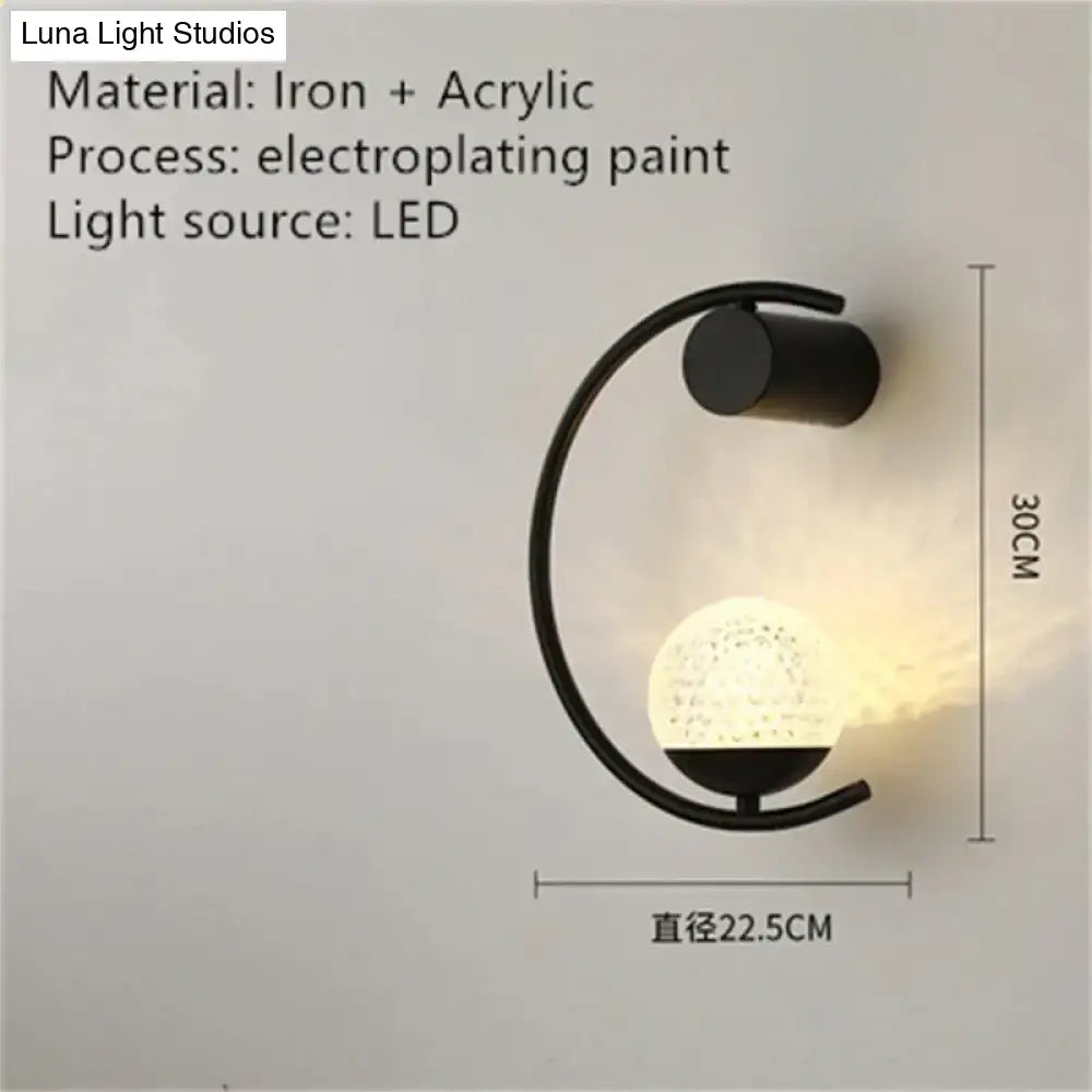 Black iron and acrylic led bedside wall sconce with curved arm and illuminated textured globe for luxury creative led use