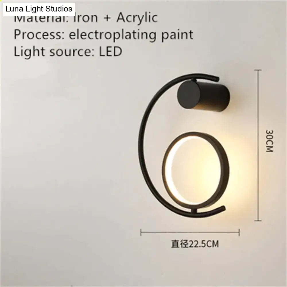 Black iron and acrylic luxury creative led bedside wall sconce with sleek curved design and warm led light source