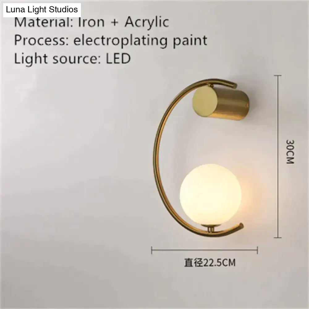 Modern gold luxury creative led bedside wall lamp with curved iron frame and frosted acrylic globe for bedroom sconce
