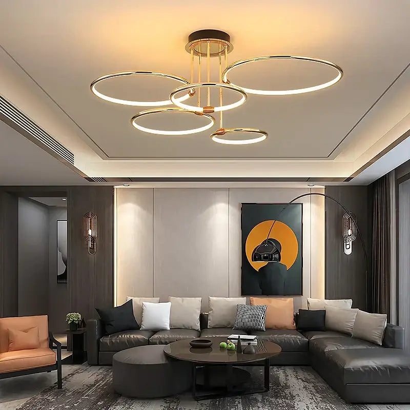 Modern gold luxury ring pendant chandelier with illuminated circular rings suspended from a brass frame for dining room decorbites gold luxury
