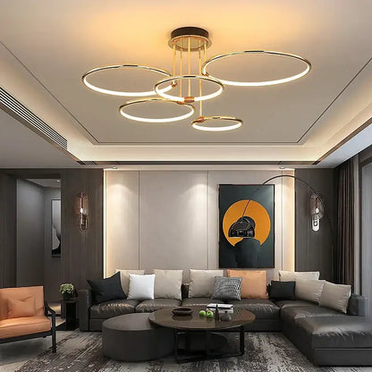 Modern gold luxury ring pendant chandelier with illuminated circular rings suspended from a brass frame for dining room decorbites gold luxury