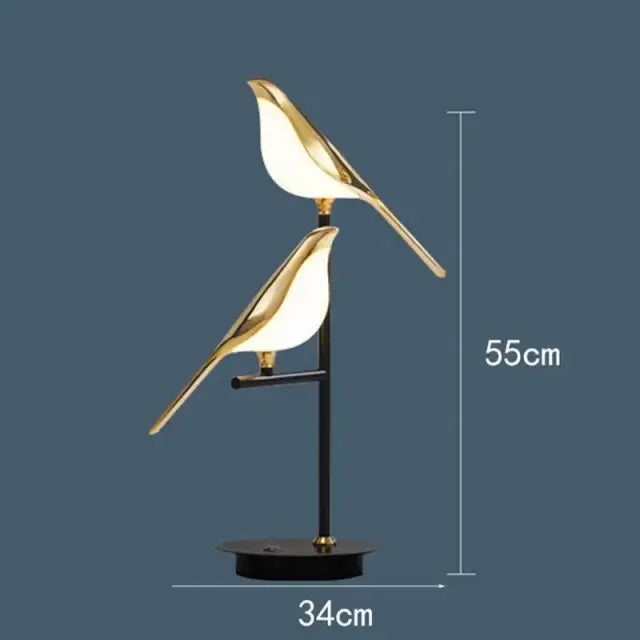 Modern gold magpie bird led ring chandelier with gold-toned bird-shaped table lamp and black sleek stand decorbites gold magpie