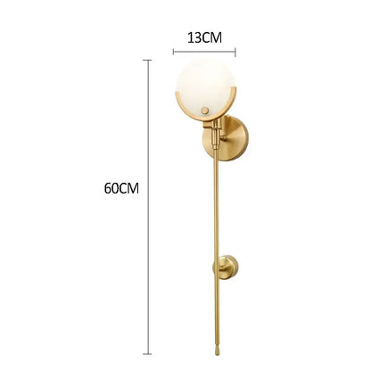 Modern gold marble wall lights featuring a gold-toned wall sconce with frosted glass globe for bedroom decorbites gold marble decor
