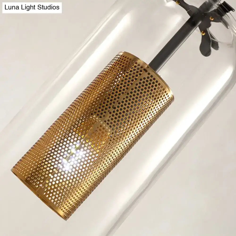 Modern gold-toned perforated metal cylindrical hanging light with clear glass suitable for 220v-240v and 110v-120v use