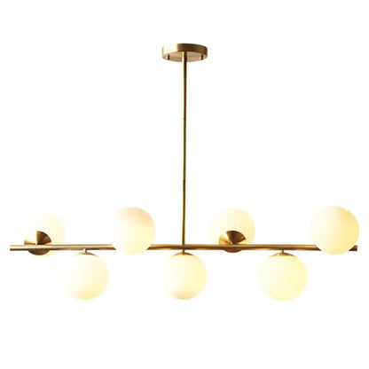 Modern gold metal island pendant dining room chandelier with six frosted white glass globe shades in linear design