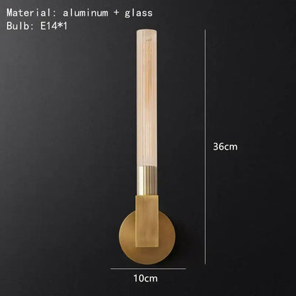 A modern gold metal and glass wall sconce light with brass-finished aluminum base for bathroom use