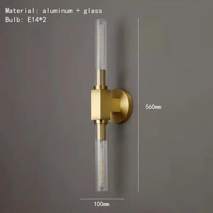 Modern gold metal and glass wall sconce light with two clear cylindrical glass tubes for bathroom use