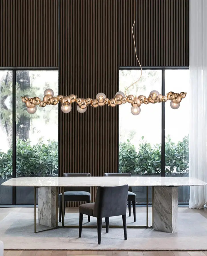 Modern gold metal arched ceiling light with six spherical glass bulbs for dining room illumination