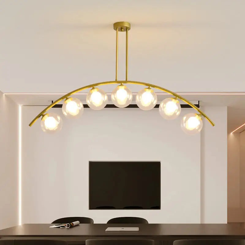 Modern gold metal arched ceiling light with six spherical glass bulbs for dining room illumination
