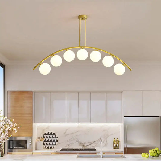 Modern gold metal arched ceiling light with six frosted glass bulbs for dining room illumination