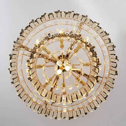Modern gold metal crystal chandelier with multiple tiers of faceted prisms and polished metal arms for dining room decorbites gold metal