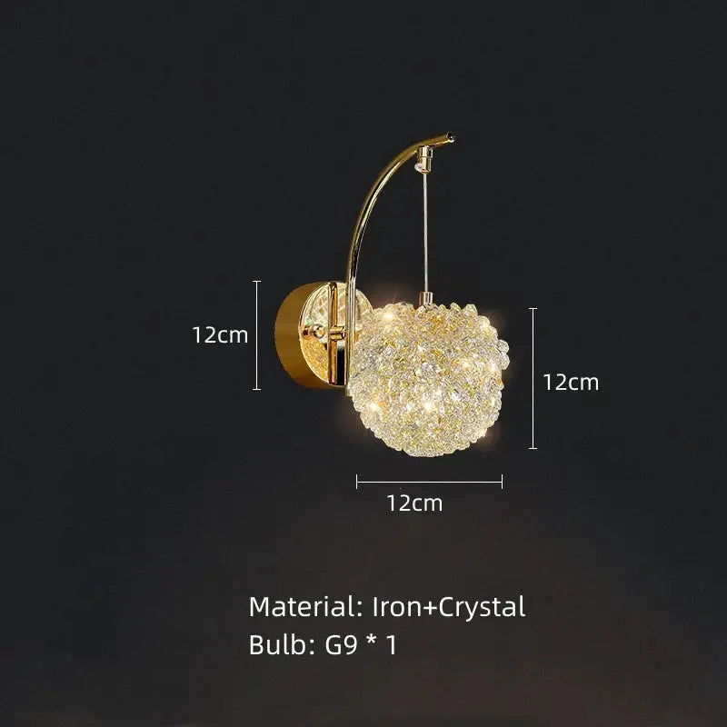 Modern gold metal crystal wall light featuring a gold metal crystal cluster on an arched iron arm bedroom sconce