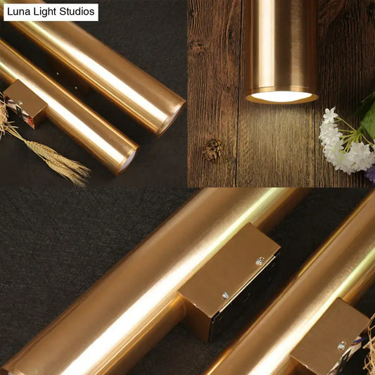 Modern gold copper-finished metal fixture wall lamp with cylindrical design and warm glow for corridor lighting