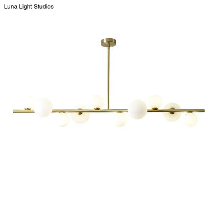 Modern gold metal chandelier with frosted glass globe bulbs and adjustable chain cord length for dining table lighting