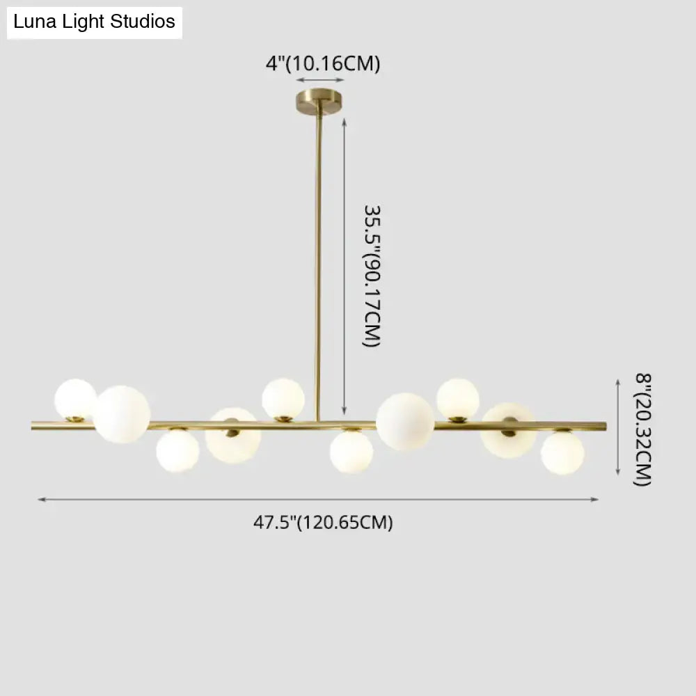 Modern gold metal glass globe chandelier with sleek horizontal bar and chain cord length for dining table lighting