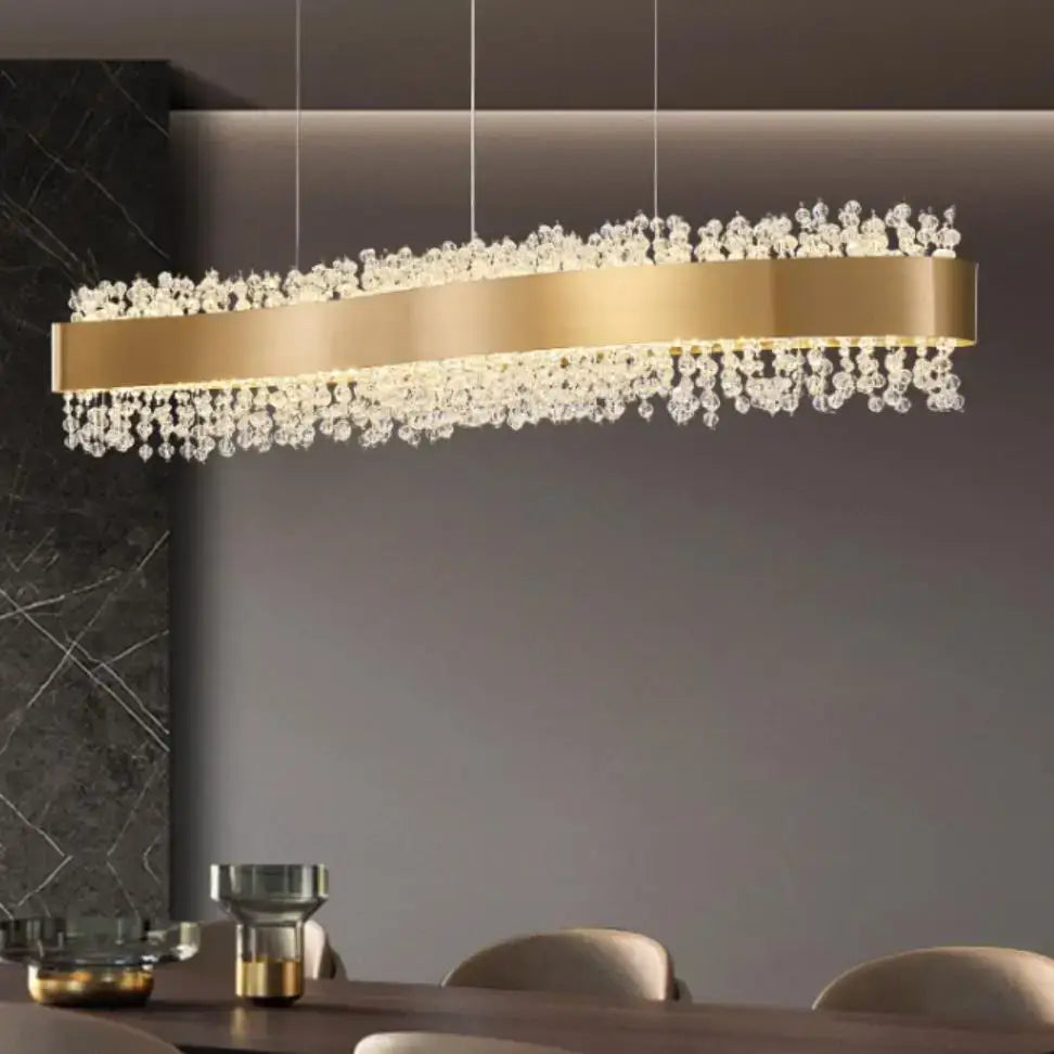 Modern gold metal led chandelier with gold-toned rectangular frame and cascading clear crystal droplets for dining room decorbites gold metal