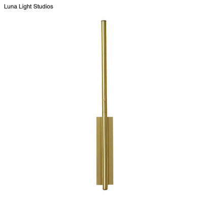Modern gold metal linear wall light with sleek cylindrical design and rectangular base for bedroom use