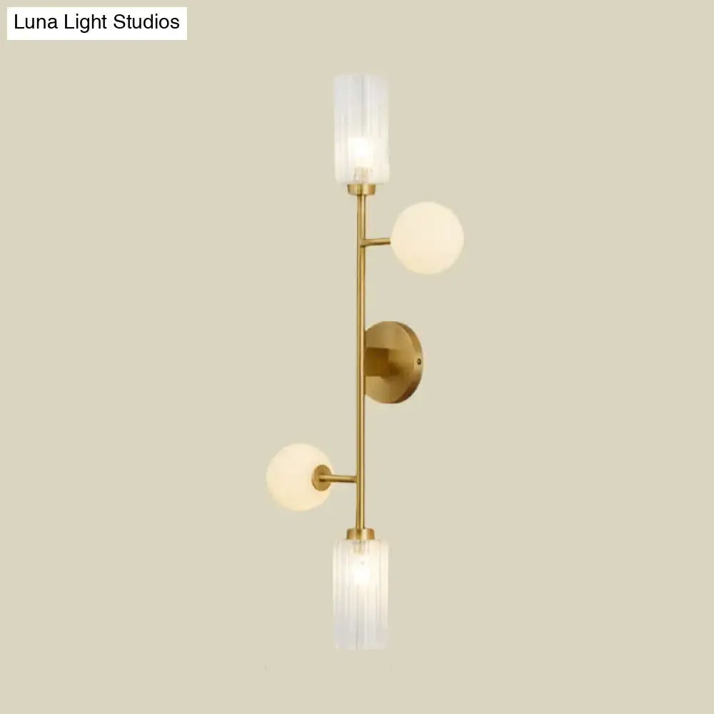 Modern gold metal pencil arm wall lamp with three illuminated frosted glass shades for bedroom lighting
