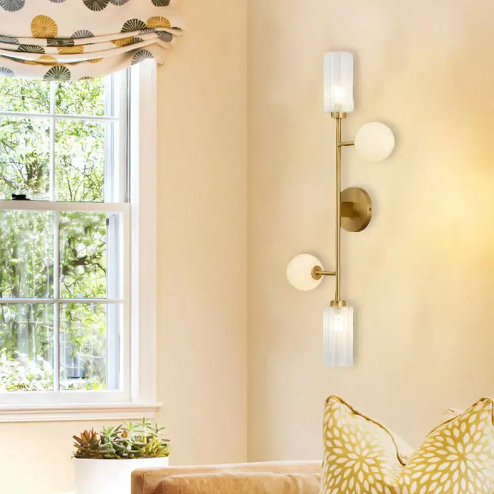 Modern gold metal pencil arm wall lamp with three frosted glass shades for bedroom lighting with metal pencil arm design