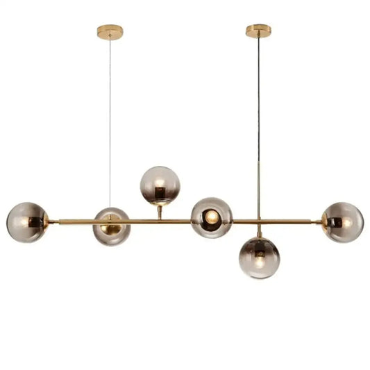Modern gold metal pendant lighting featuring brass and smoked glass spherical bulbs for dining room use