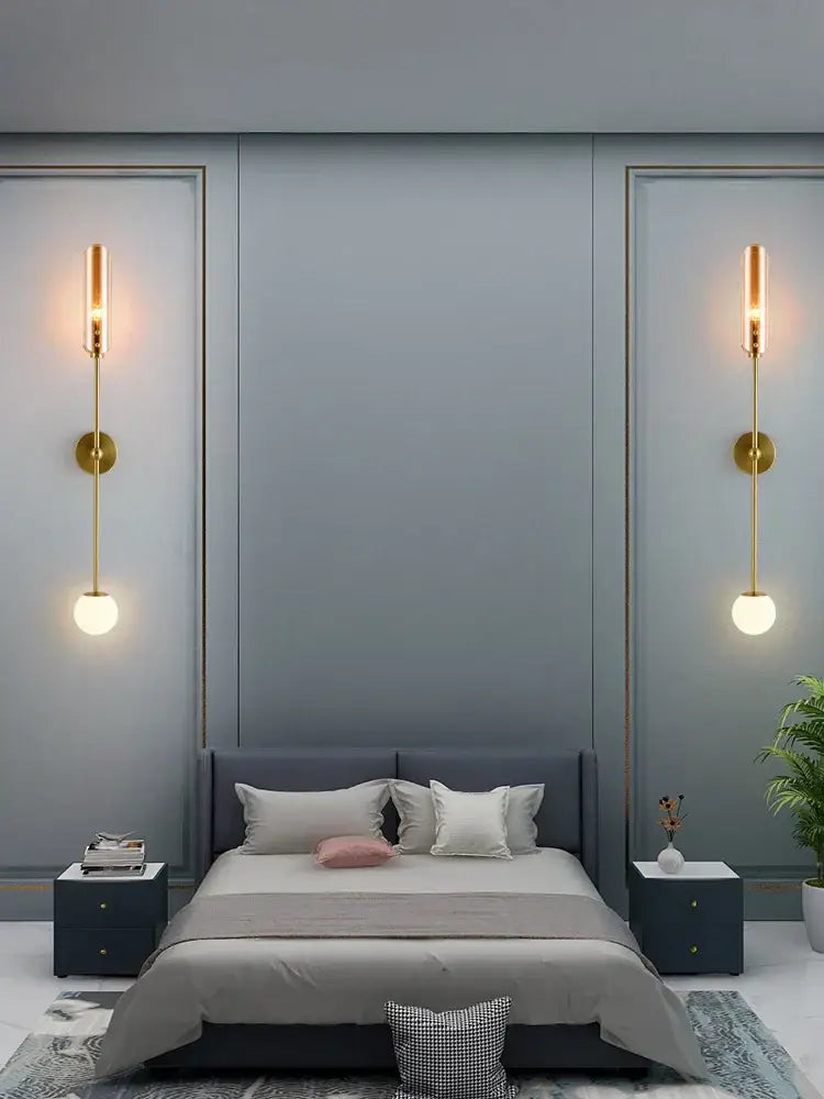 Modern gold metal wall light featuring gold-toned vertical sconces with frosted globe shades for bedroom decorbites gold metal