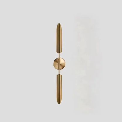 Modern gold metal wall sconce with sleek vertical cylindrical arms and frosted globe for bedroom decorbites gold metal light