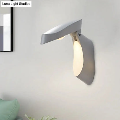 Modern gold metal wall light bedside fixture with sleek angular gray wall sconce and warm ambient lighting
