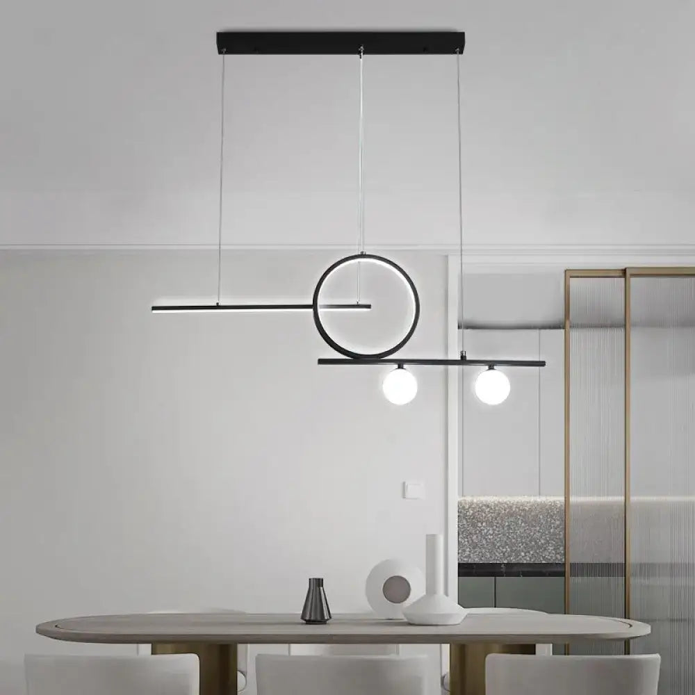 Modern black minimalist pendant light with globe acrylic shade and two spherical bulbs for dining room use